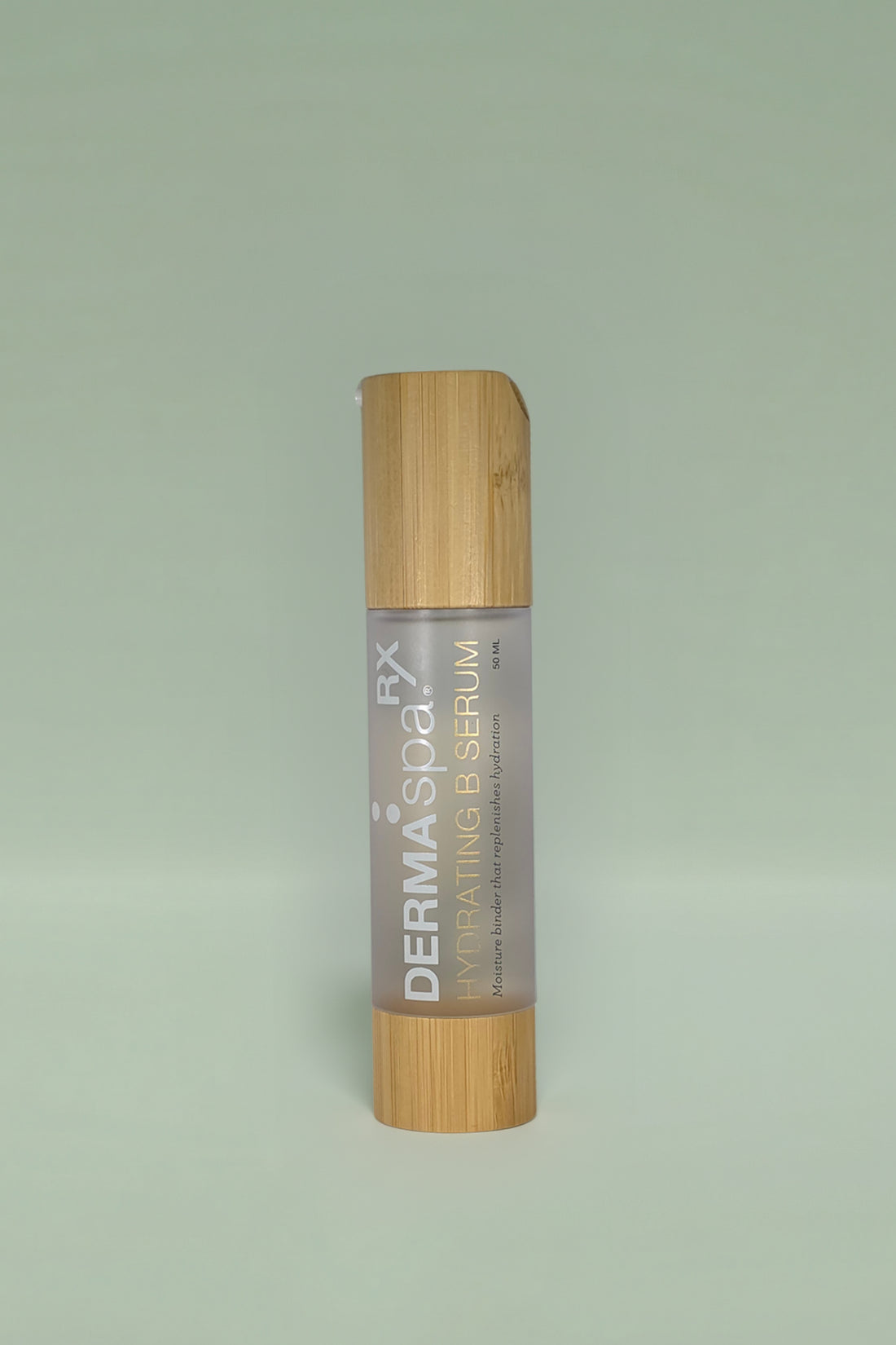 Dermaspa Rx Hydrating B Serum with bamboo cap on a light green background